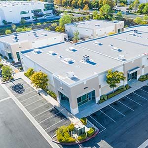 Top view of a commercial building with a flat, white roof
